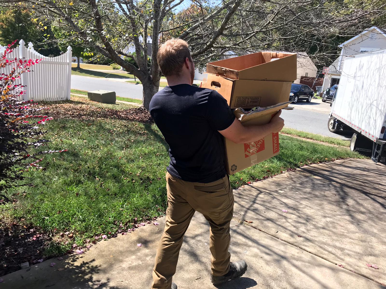 Junk Raider crew member hauling junk during a Charlotte cleanout