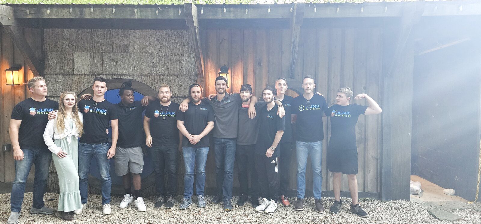 The Junk Raider team standing together in front of their branded location in Mooresville, NC