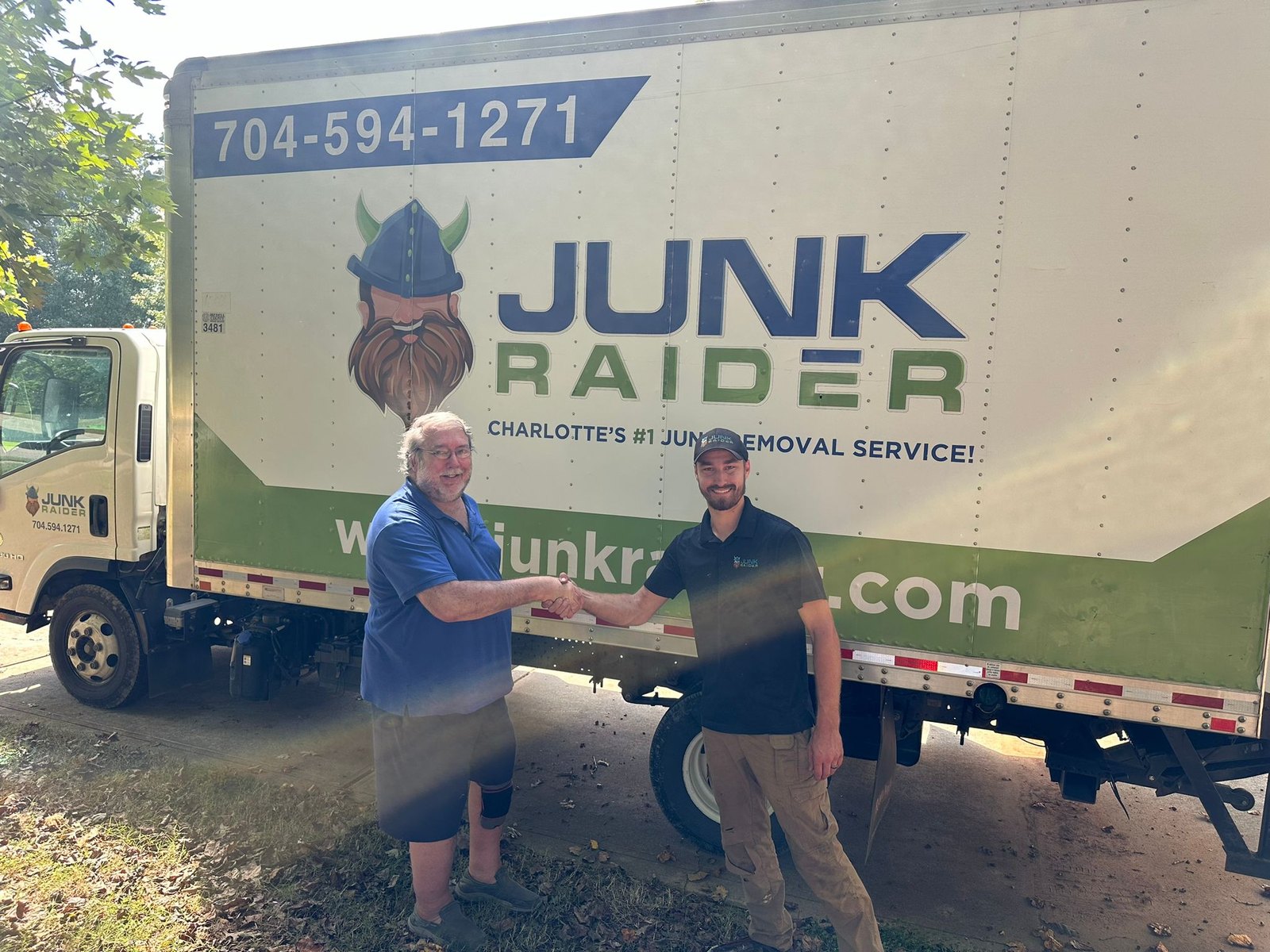 Junk Raider crew member shaking hands with a resident’s family member outside a senior living community in Charlotte, NC